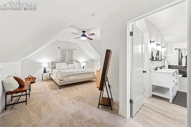 bedroom with vaulted ceiling, ceiling fan, and sink