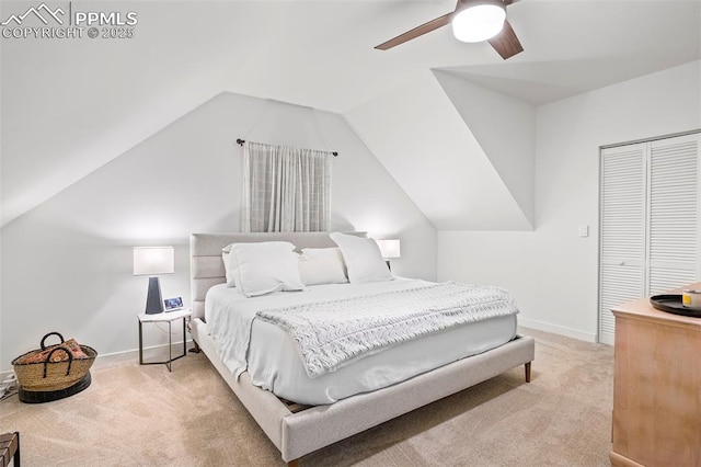 carpeted bedroom featuring ceiling fan, vaulted ceiling, and a closet