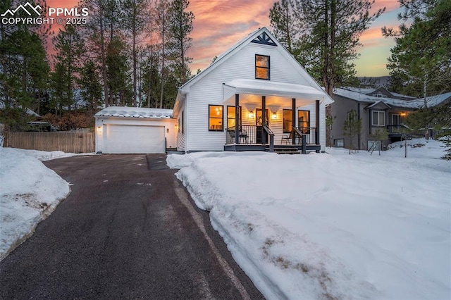 view of front of property with covered porch and a garage