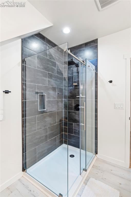 bathroom featuring a shower with shower door