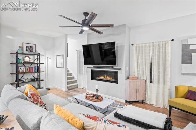 living room with ceiling fan and light hardwood / wood-style floors