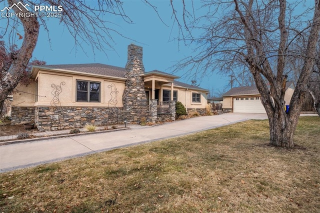 view of front of home with a front yard and a garage