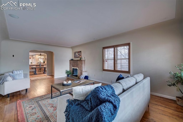 living room featuring hardwood / wood-style floors and a high end fireplace