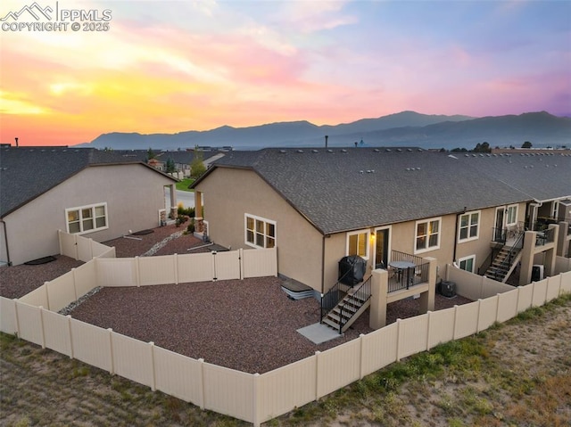 back house at dusk with a mountain view