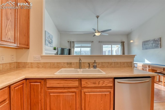 kitchen featuring ceiling fan, dishwasher, and sink