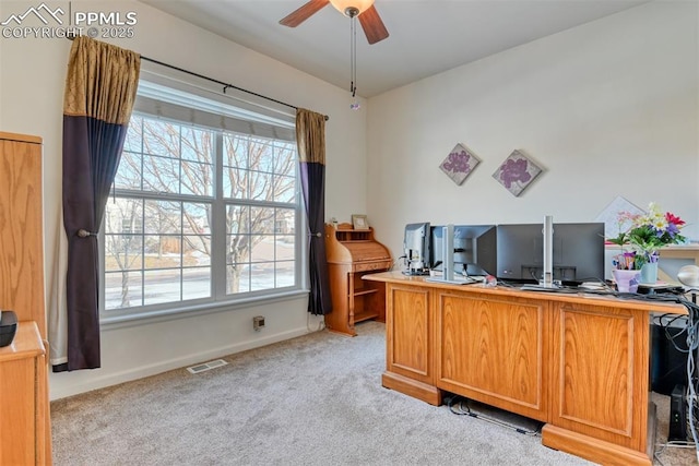 carpeted home office with ceiling fan