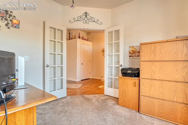 carpeted office featuring french doors