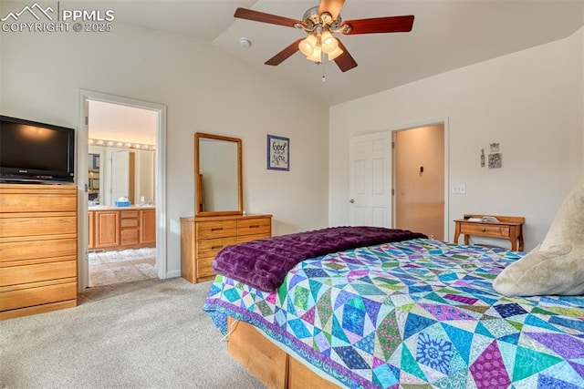 carpeted bedroom with ensuite bathroom, ceiling fan, and vaulted ceiling