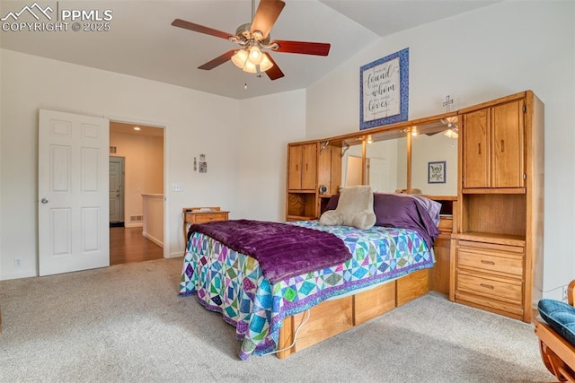 carpeted bedroom featuring ceiling fan and vaulted ceiling