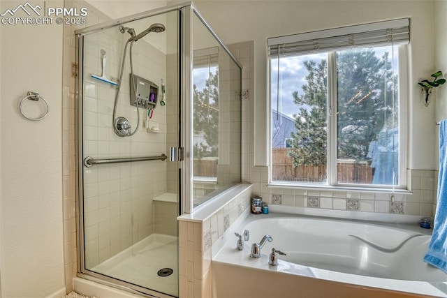 bathroom with shower with separate bathtub