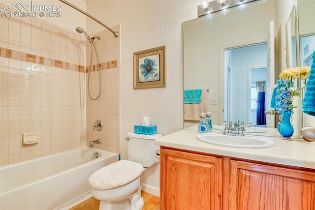 full bathroom with toilet, tiled shower / bath combo, and vanity