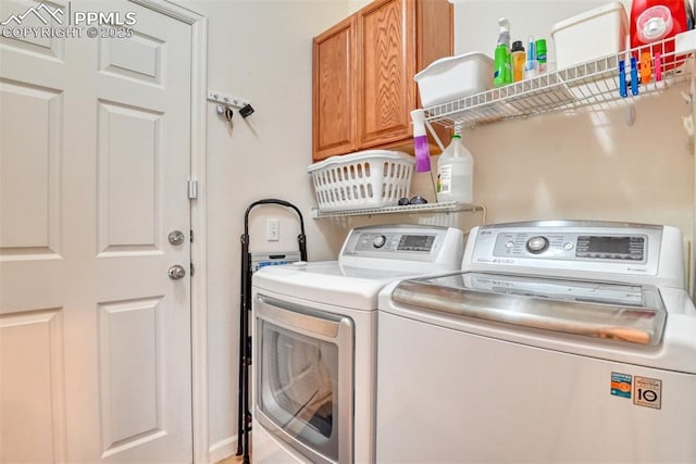 laundry area featuring cabinets and washer and clothes dryer