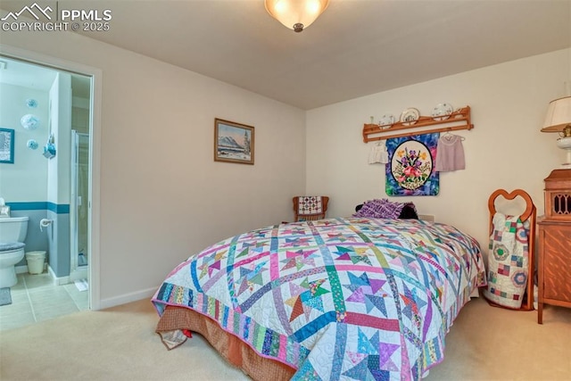 bedroom featuring ensuite bathroom and carpet floors