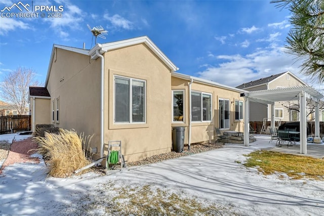 snow covered property featuring a patio and a pergola