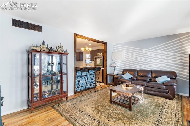 living room featuring hardwood / wood-style floors and a chandelier