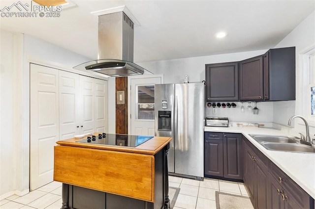 kitchen featuring island range hood, sink, stainless steel fridge, black electric stovetop, and light tile patterned floors