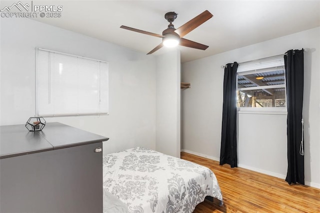 bedroom with ceiling fan and light hardwood / wood-style floors