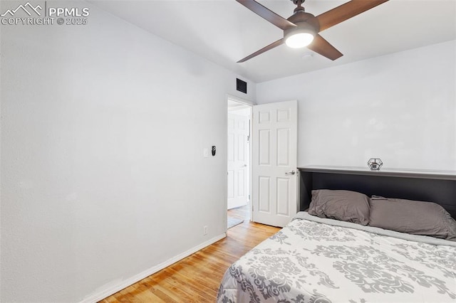 bedroom with ceiling fan and light hardwood / wood-style flooring