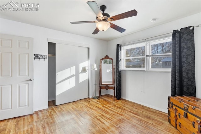 bedroom with ceiling fan, light hardwood / wood-style floors, and a closet