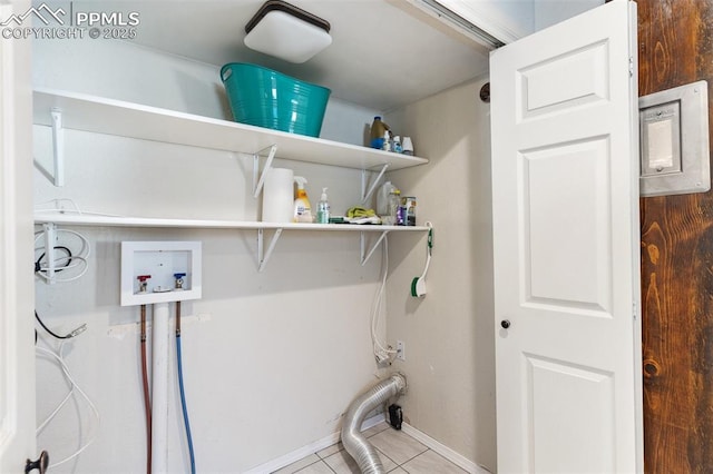 laundry room featuring washer hookup and light tile patterned floors