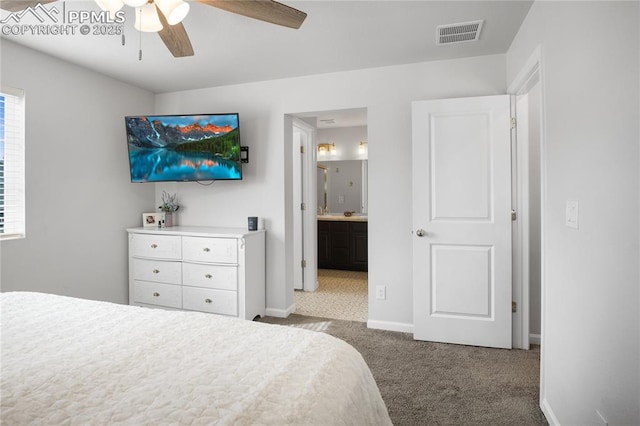 carpeted bedroom with connected bathroom and ceiling fan