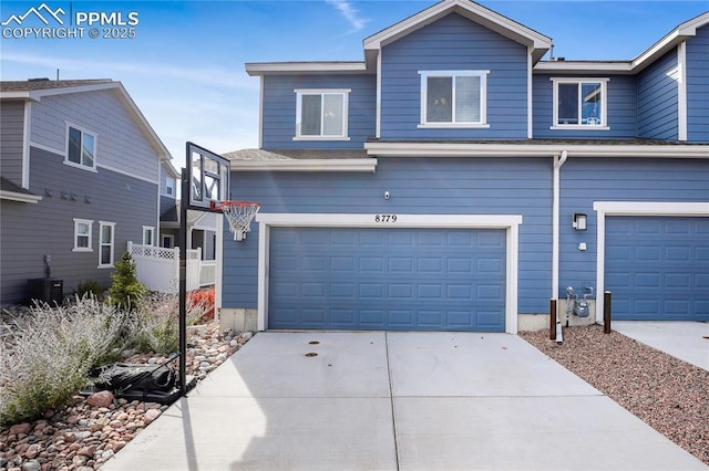 view of front of house with central AC unit and a garage