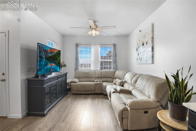 living room with ceiling fan and light hardwood / wood-style floors