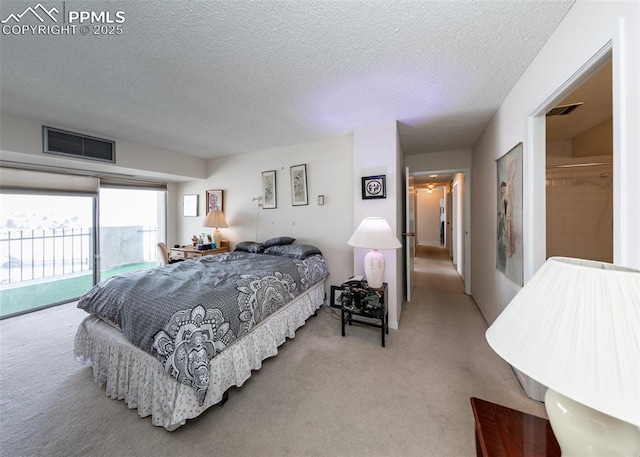 bedroom with access to outside, light colored carpet, and a textured ceiling