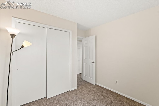 unfurnished bedroom with light carpet and a closet