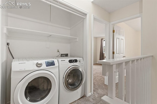 clothes washing area featuring light colored carpet and washing machine and clothes dryer