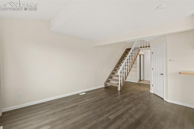 unfurnished living room with dark hardwood / wood-style flooring