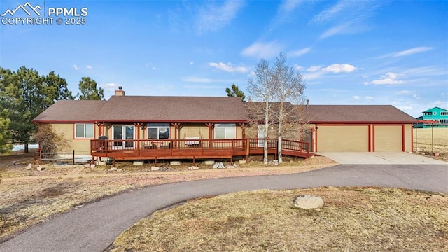 view of front of home featuring a deck and a garage