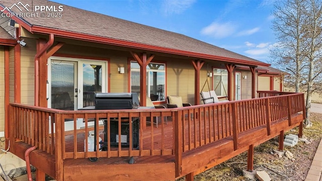 wooden deck with a grill