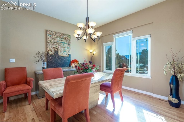 dining room featuring light hardwood / wood-style floors and an inviting chandelier