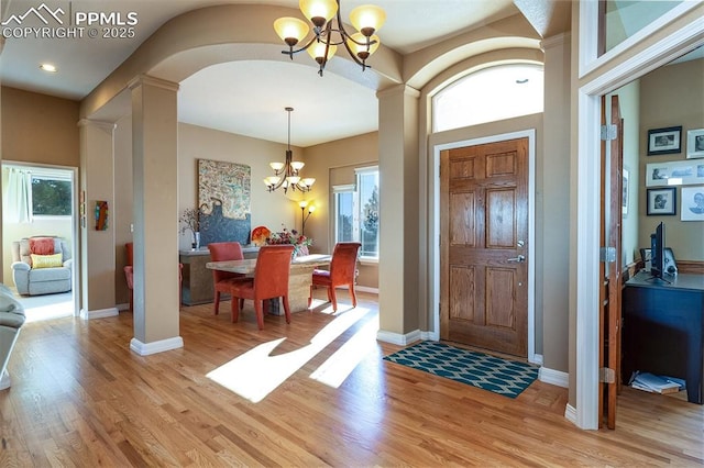 entrance foyer with a chandelier and light wood-type flooring