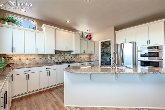 kitchen featuring white cabinets, appliances with stainless steel finishes, and sink