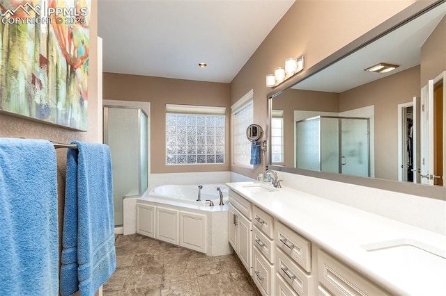 bathroom featuring shower with separate bathtub and vanity