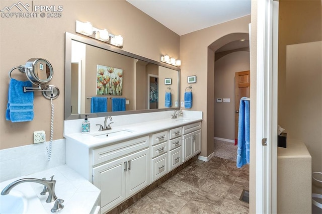 bathroom with vanity and a bath