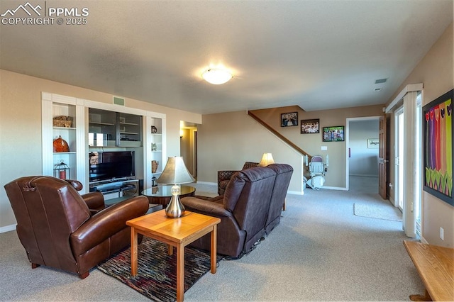 living room featuring built in shelves and carpet floors