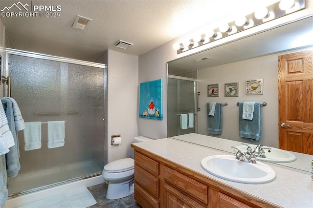 bathroom with vanity, an enclosed shower, and toilet