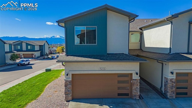 view of front of home with a mountain view and a garage