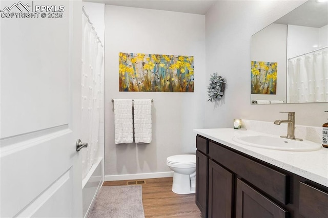 full bathroom featuring shower / bathtub combination with curtain, vanity, wood-type flooring, and toilet