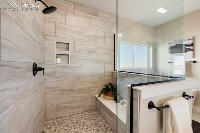 bathroom with tiled shower