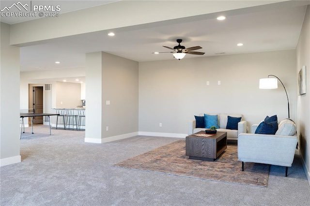 carpeted living room with ceiling fan