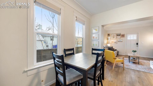 dining room with baseboards and light wood finished floors