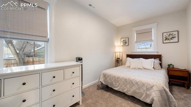 carpeted bedroom with visible vents and baseboards