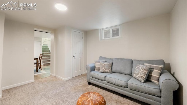 living area featuring stairs, baseboards, and carpet flooring