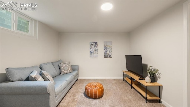 living area featuring carpet flooring and baseboards