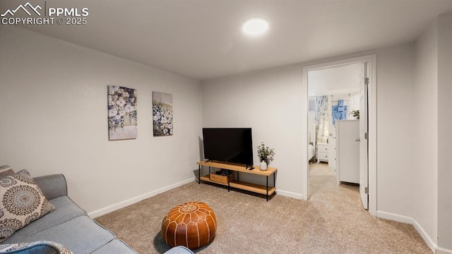 carpeted living area with baseboards