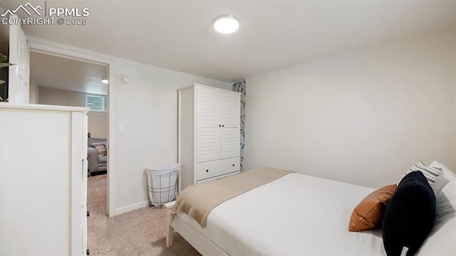 bedroom featuring carpet flooring and baseboards